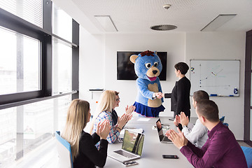 Image showing boss dresed as bear having fun with business people in trendy of