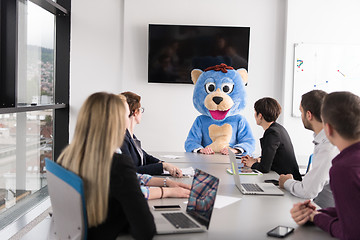 Image showing boss dresed as bear having fun with business people in trendy of