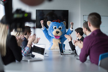 Image showing boss dresed as bear having fun with business people in trendy of