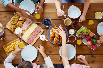 Image showing group of people having breakfast at table