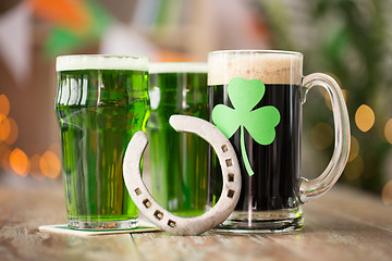 Image showing shamrock on glass of beer and horseshoe on table