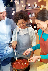 Image showing happy women and chef cook cooking in kitchen