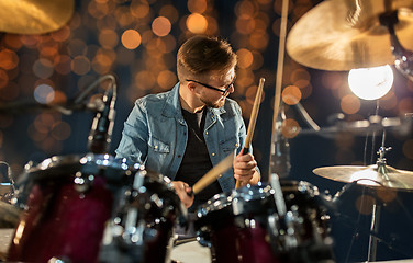 Image showing male musician playing drums and cymbals at concert