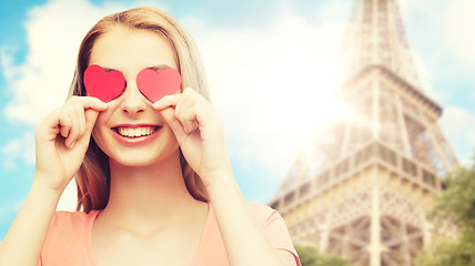 Image showing happy young woman with red heart shapes on eyes