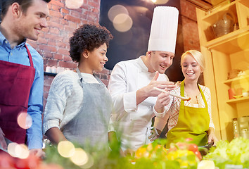 Image showing happy friends and chef cook cooking in kitchen