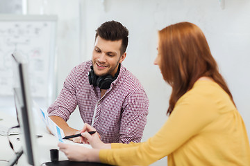 Image showing creative team with headphones and computer