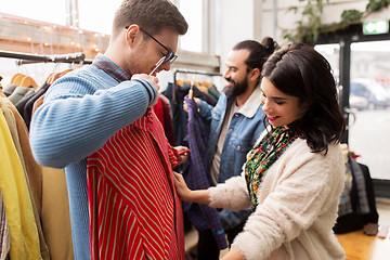 Image showing friends choosing clothes at vintage clothing store