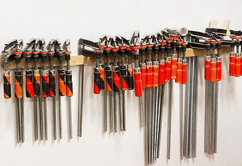 Image showing one-handed bar clamps hanging on wall