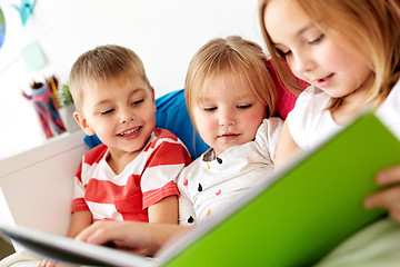 Image showing little kids reading book in bed at home