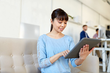 Image showing happy asian woman with tablet pc working at office