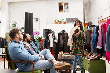 Image showing friends choosing clothes at vintage clothing store