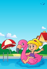 Image showing Girl floating on inflatable flamingo 3