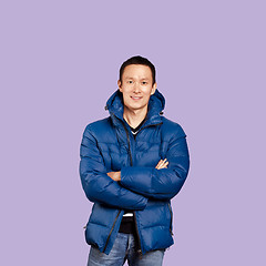 Image showing Asian man in blue down-padded coat