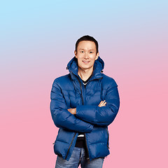 Image showing Asian man in blue down-padded coat