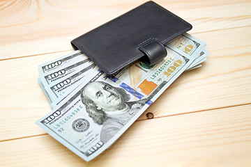 Image showing Heap of money and wallet