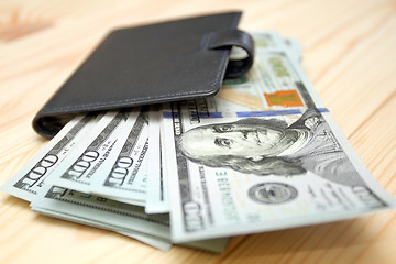Image showing Heap of money and wallet