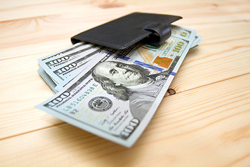 Image showing Heap of money and wallet