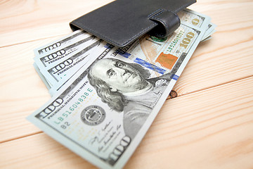 Image showing Heap of money and wallet