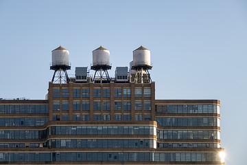 Image showing some typical water tanks on the roof of a building in New York C