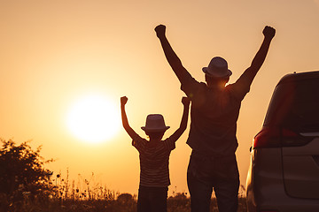 Image showing Father and son playing in the park at the sunset time.