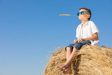 Image showing Happy little boy playing in the park at the day time.