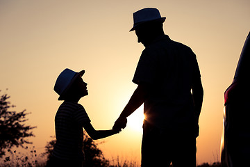 Image showing Father and son playing in the park at the sunset time.