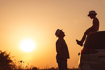 Image showing Father and son playing in the park at the sunset time.