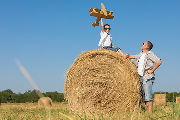 Image showing Father and son playing in the park at the day time.