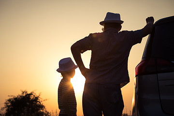 Image showing Father and son playing in the park at the sunset time.