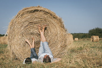 Image showing Father and son lying in the park at the day time.