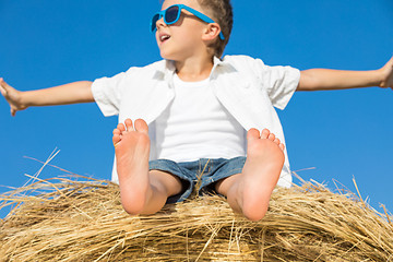 Image showing Happy little boy playing in the park at the day time.