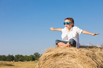 Image showing Happy little boy playing in the park at the day time.