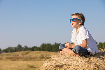 Image showing Happy little boy playing in the park at the day time.