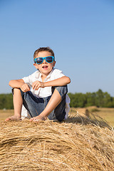 Image showing Happy little boy playing in the park at the day time.