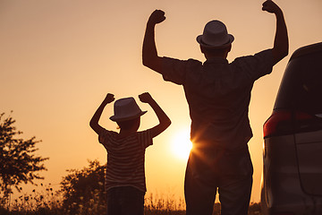 Image showing Father and son playing in the park at the sunset time.