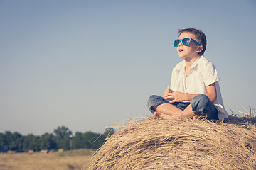 Image showing Happy little boy playing in the park at the day time.