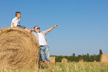 Image showing Father and children standing in the park at the day time.