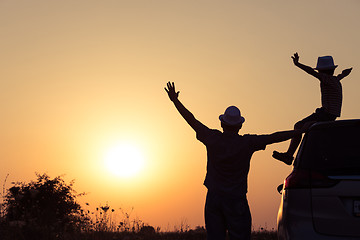 Image showing Father and son playing in the park at the sunset time.