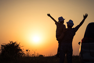 Image showing Father and son playing in the park at the sunset time.