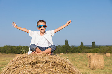 Image showing Happy little boy playing in the park at the day time.