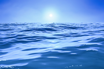 Image showing a blue ocean with sun over the horizon