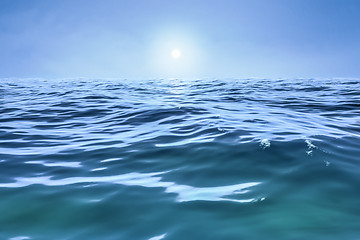 Image showing a blue ocean with sun over the horizon