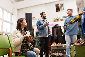 Image showing friends choosing clothes at vintage clothing store