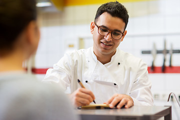 Image showing chef at fast food restaurant writing order