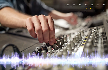 Image showing hands on mixing console in music recording studio