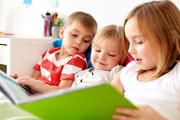 Image showing little kids reading book in bed at home