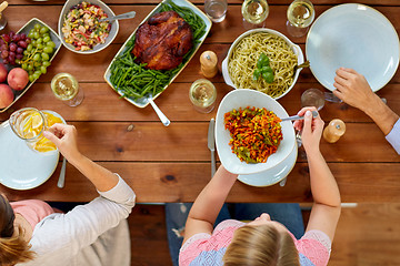 Image showing group of people eating at table with food