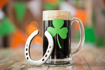 Image showing shamrock on glass of beer and horseshoe on table