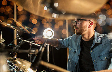 Image showing male musician playing drums and cymbals at concert