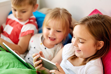 Image showing little kids with smartphone in bed at home